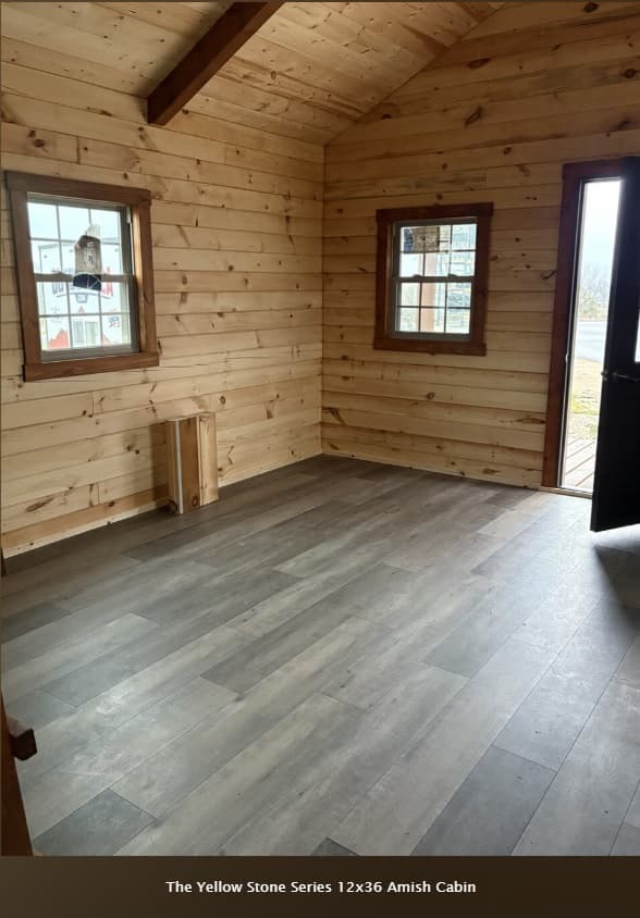 Yellowstone 12x36 cabin main living area with natural pine tongue-and-groove walls and ceiling